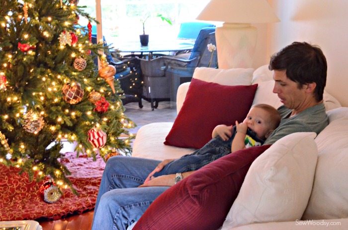 Jon and Ryder sitting by the Christmas Tree