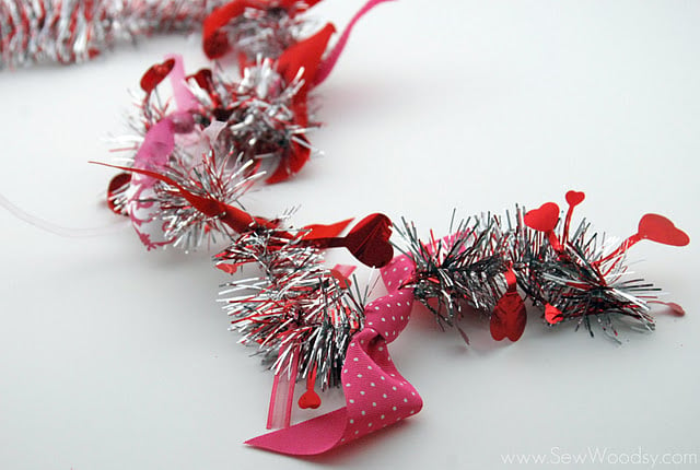 Tinsel garland with scraps of ribbon tied to it.