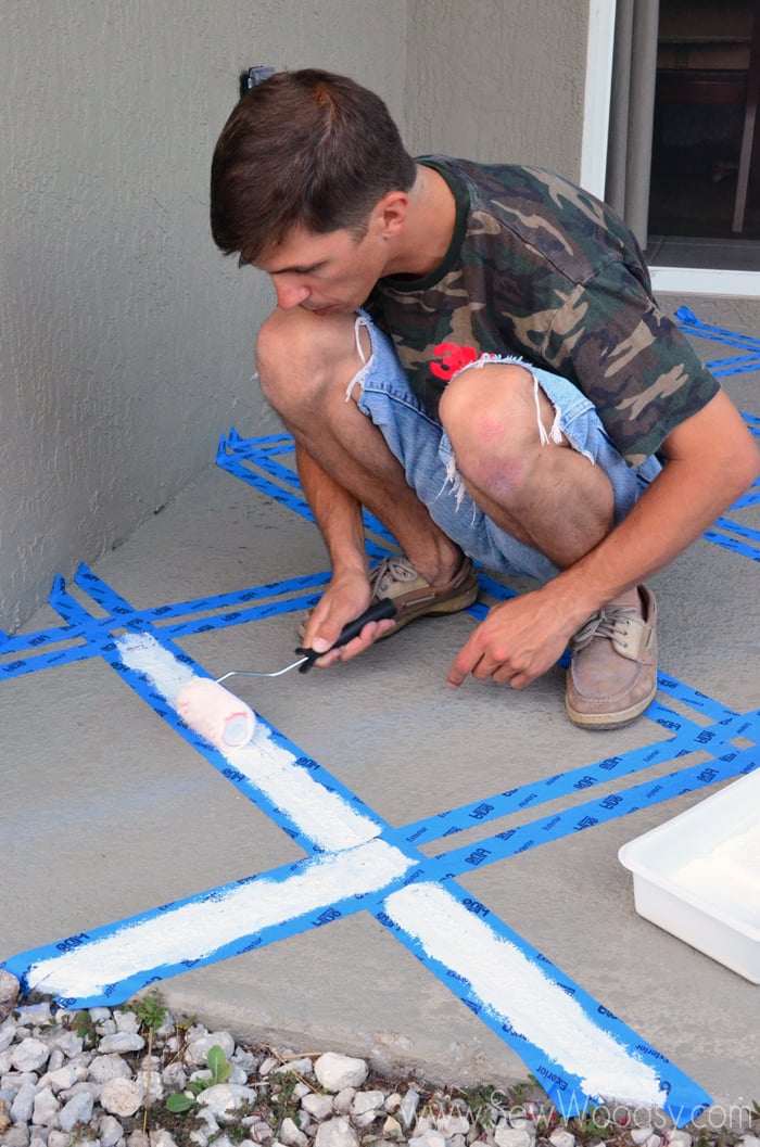 Man rolling paint onto painters tape.