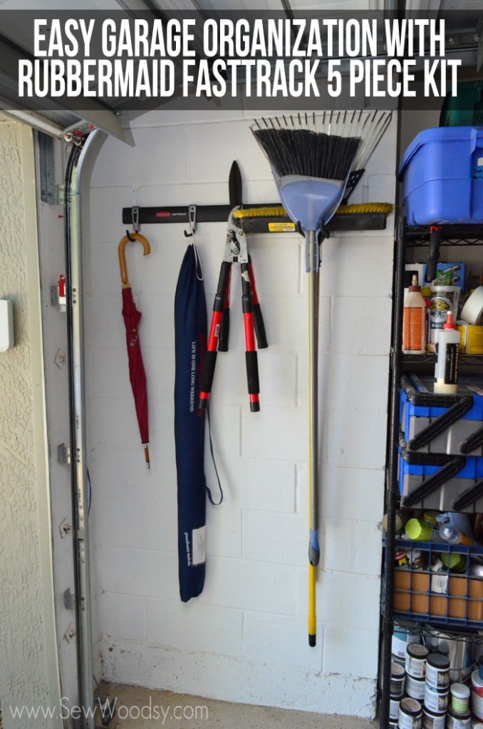 Fasttrack system on a garage wall holding a broom, hedge clippers, and umbrellas with blog post text on photo.