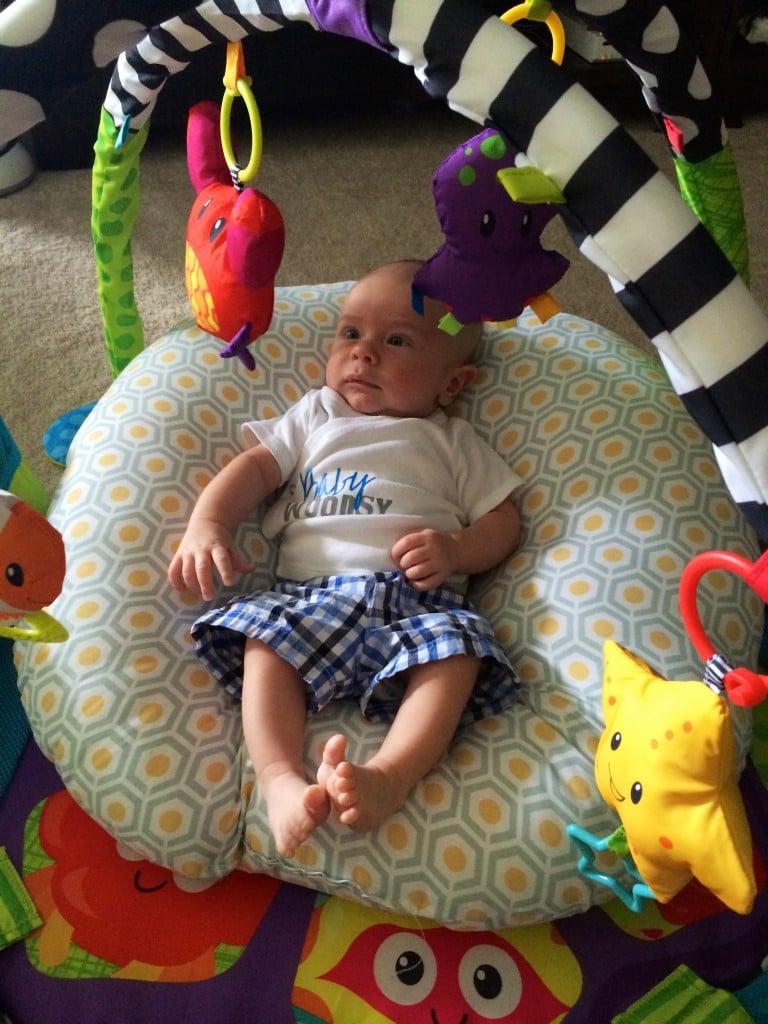 swatting toys on the activity mat 