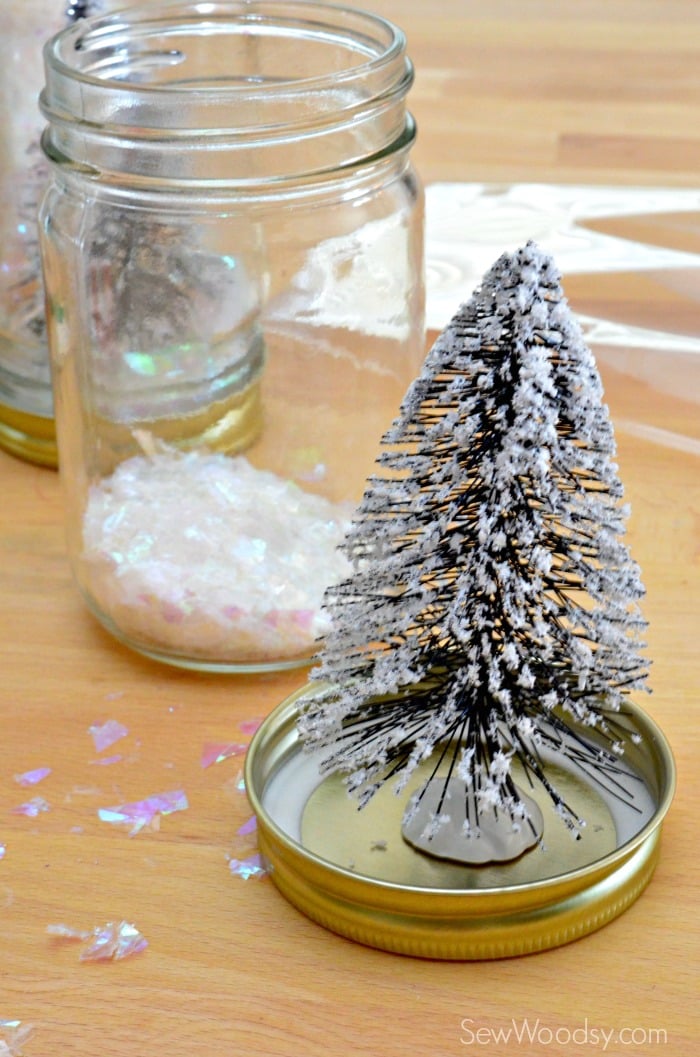 Wire bottle brush christmas tree secured to the inside of a mason jar lid.