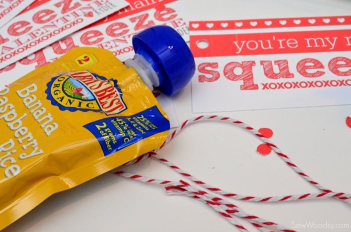 Baby food squeeze pouch with twine and valentines around it.