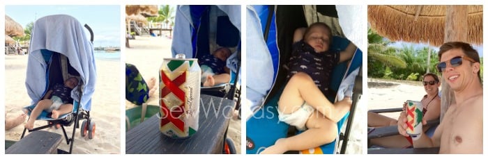 baby sleeping in a stroller on a beach with mom and dad with a beer in hand.