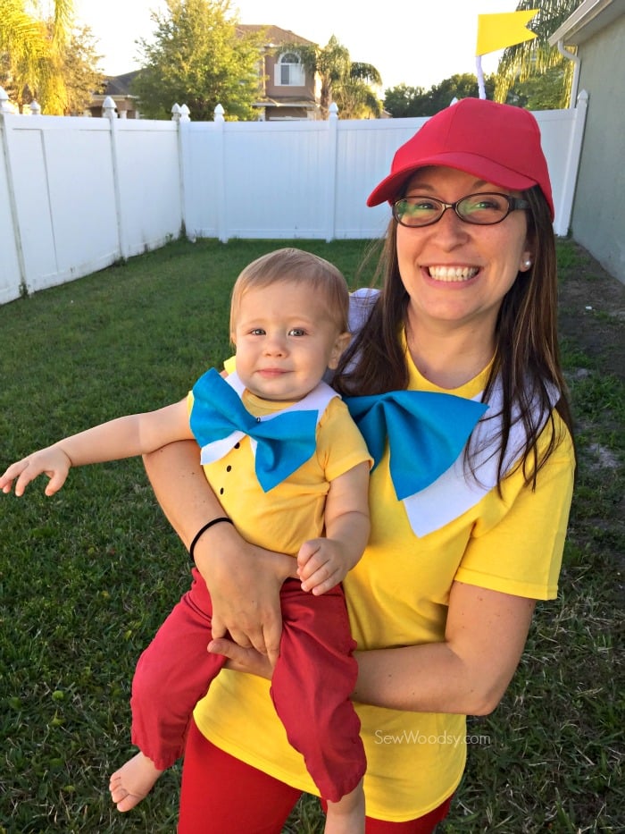 Woman and baby boy dressed as Tweedledum and Tweedledee.