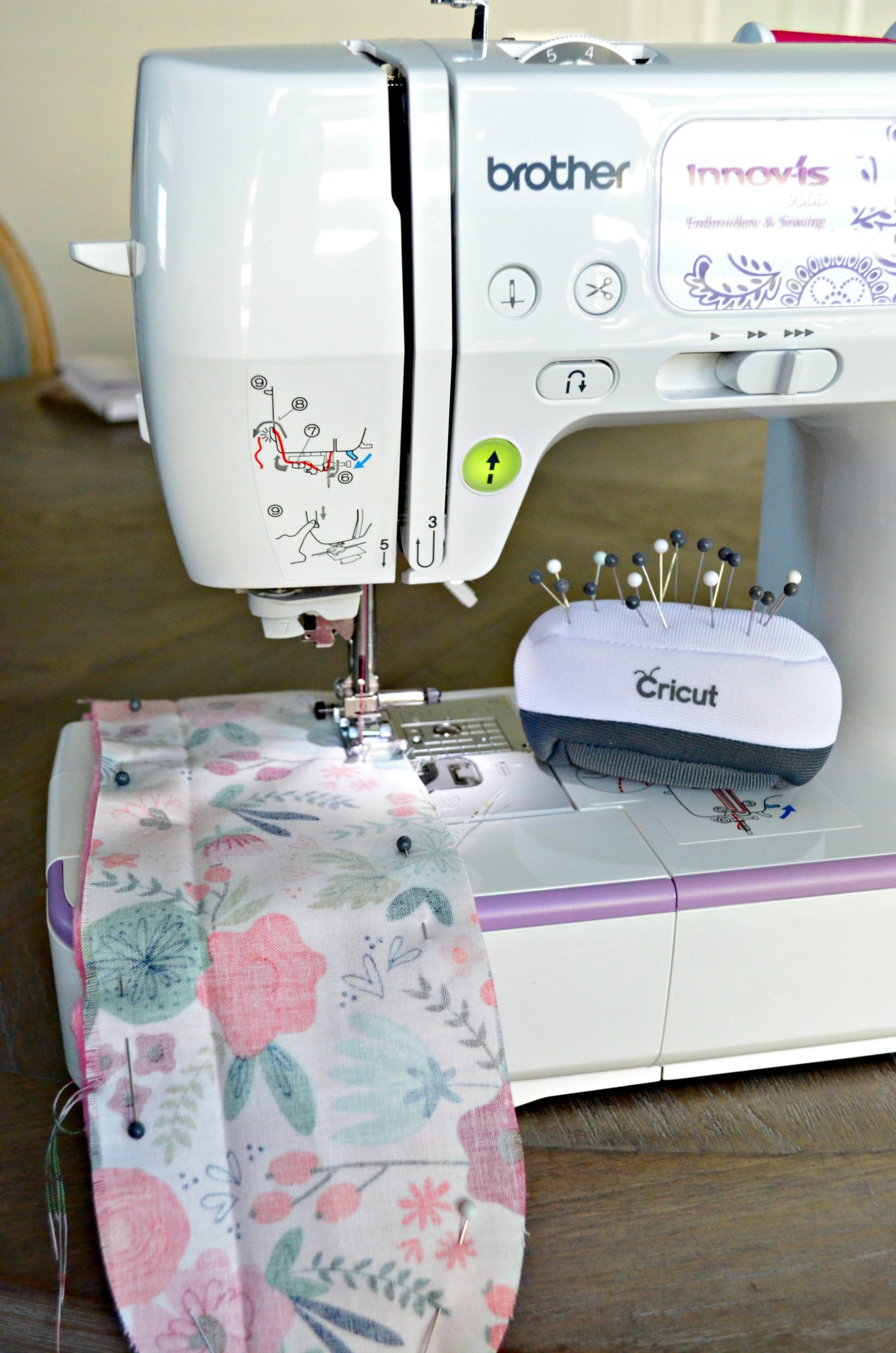 White and purple brother sewing machine sewing fabric.