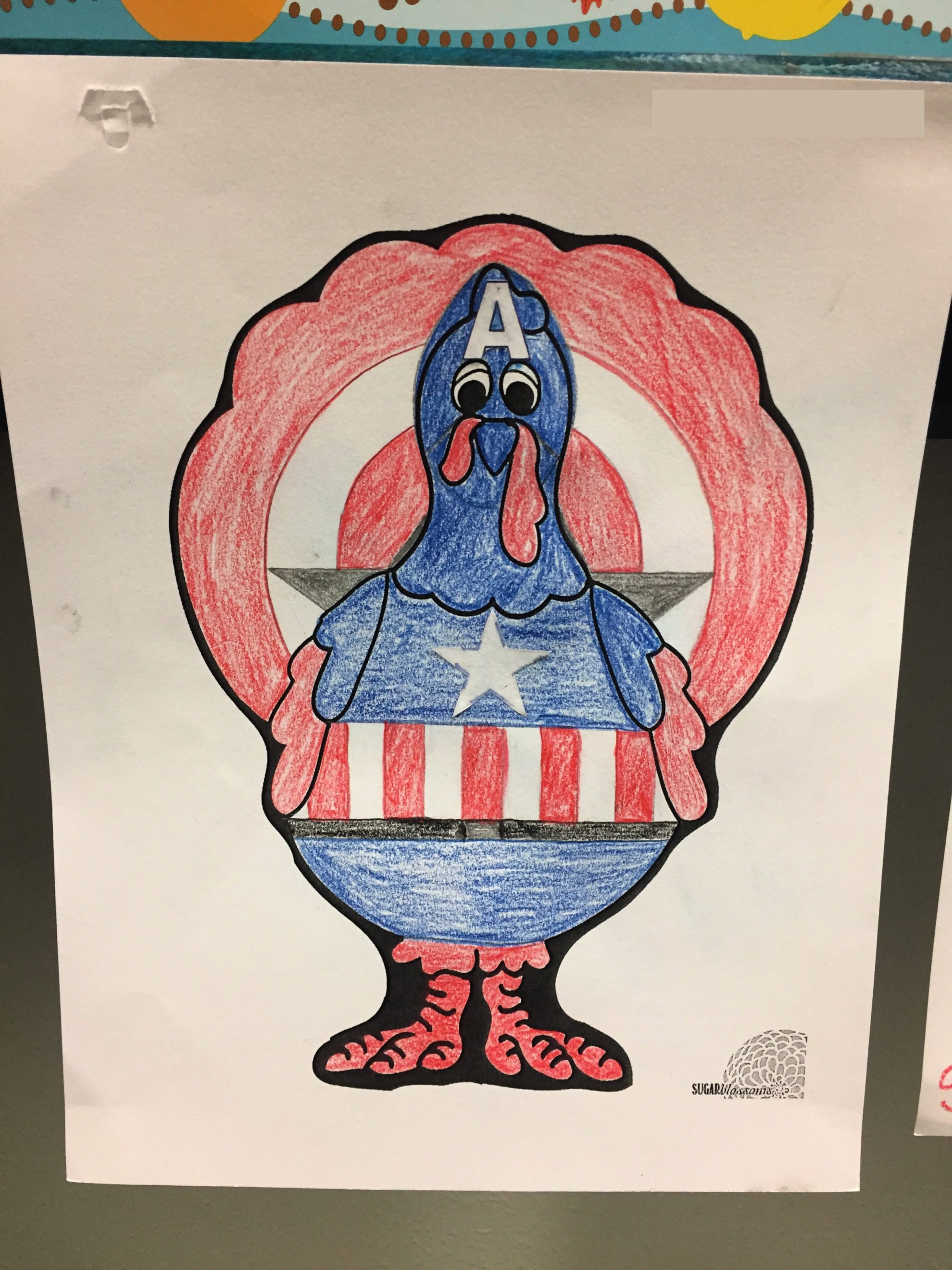 Colored Turkey In Disguise as Captain America with red white and blue crayons.