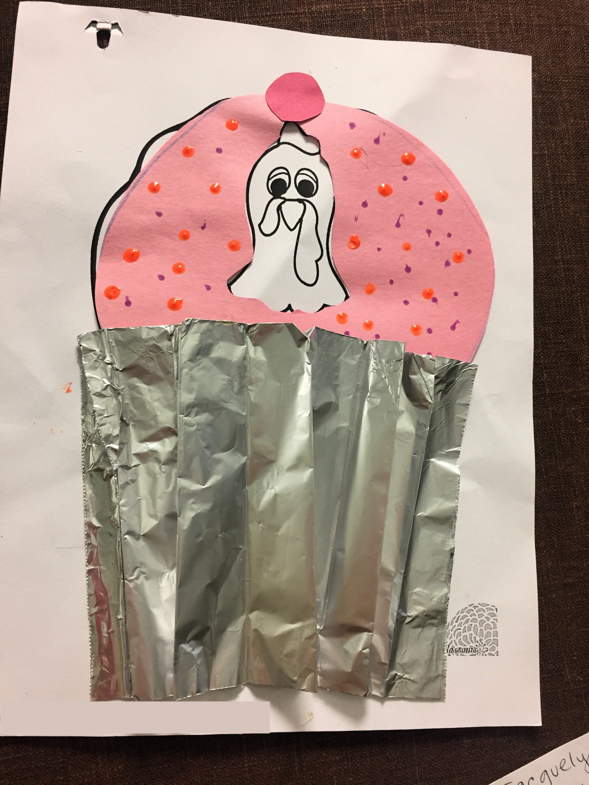Paper Turkey In Disguise dressed as a Cupcake with tinfoil wrapper and pink construction paper with little dots as sprinkles.