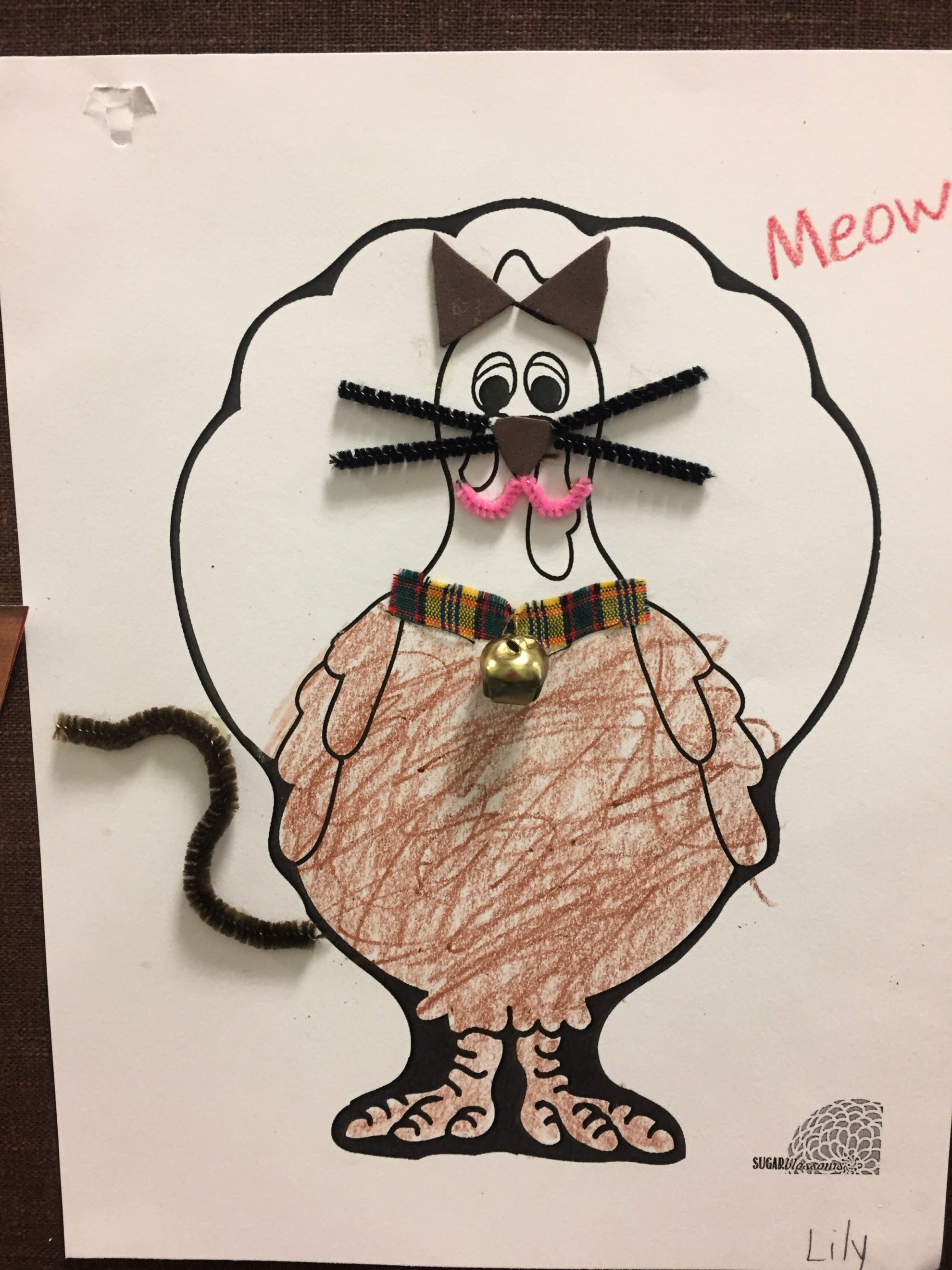 Paper Turkey In Disguise as a colored brown Kitty Cat with pipe cleaner whiskers, tail, and a cloth collar with real bell.