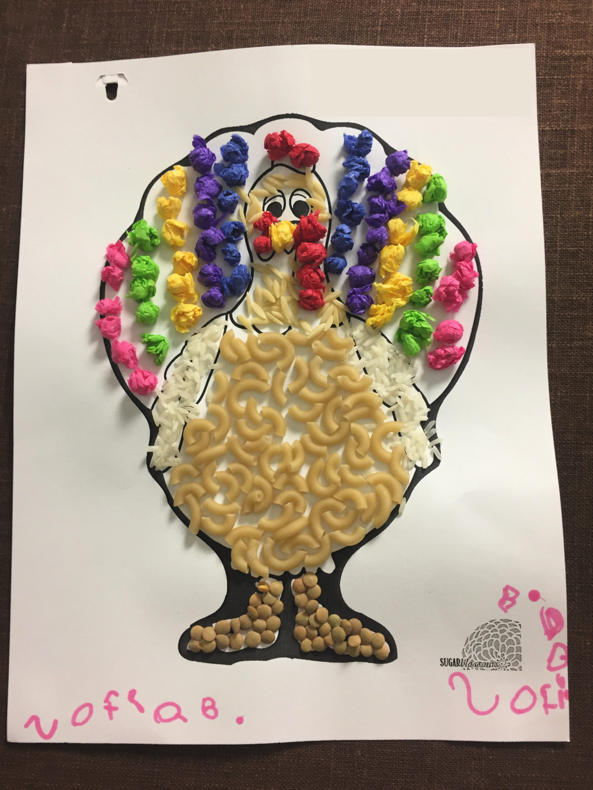 Paper Turkey In Disguise with macaroni noodles nad rice glued to it with little tissue paper balls made into a Rainbow.