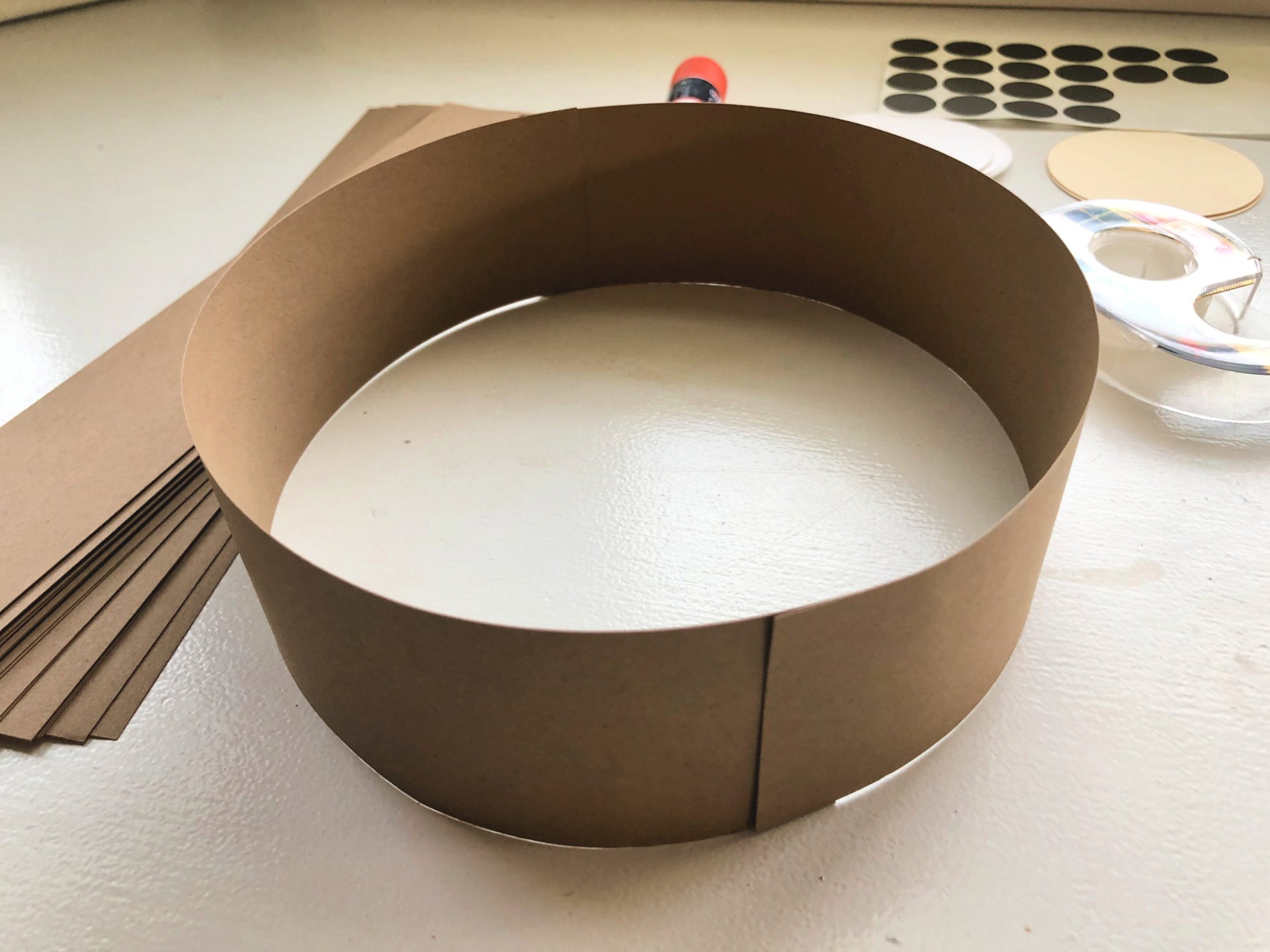 Two pieces of brown cardstock taped together to make a circular headband.