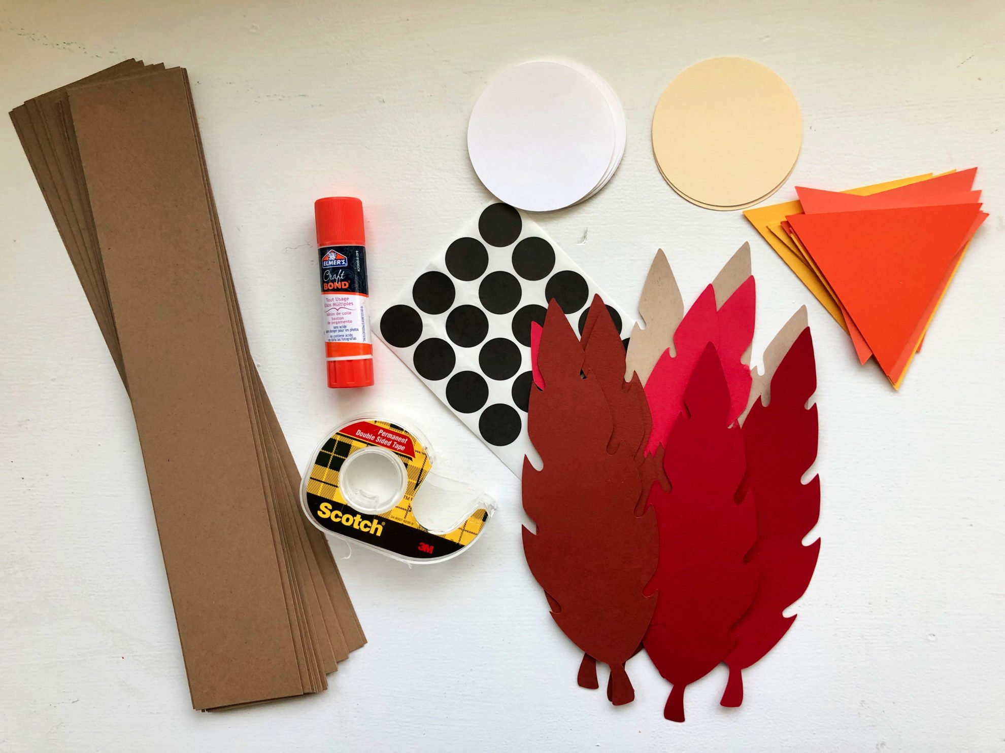 Supplies: brown card stock strips, paper feathers, orange paper beaks, tape, glue, black dots.