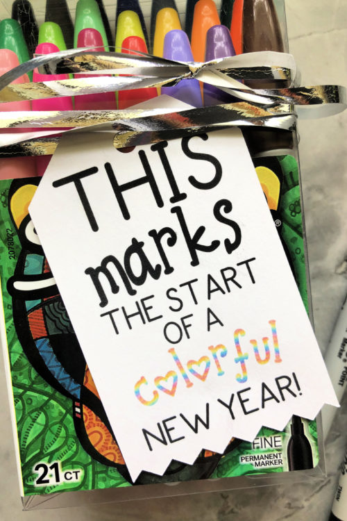 Close up of a tag that reads "This Marks The Start Of A Colorful New Year - New School Year Gift"