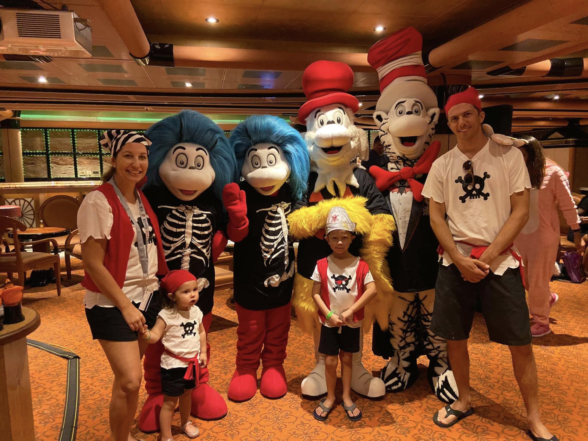 Family dressed as pirates posing with thing 1 and thing 2, sam I am and Cat and the hat.