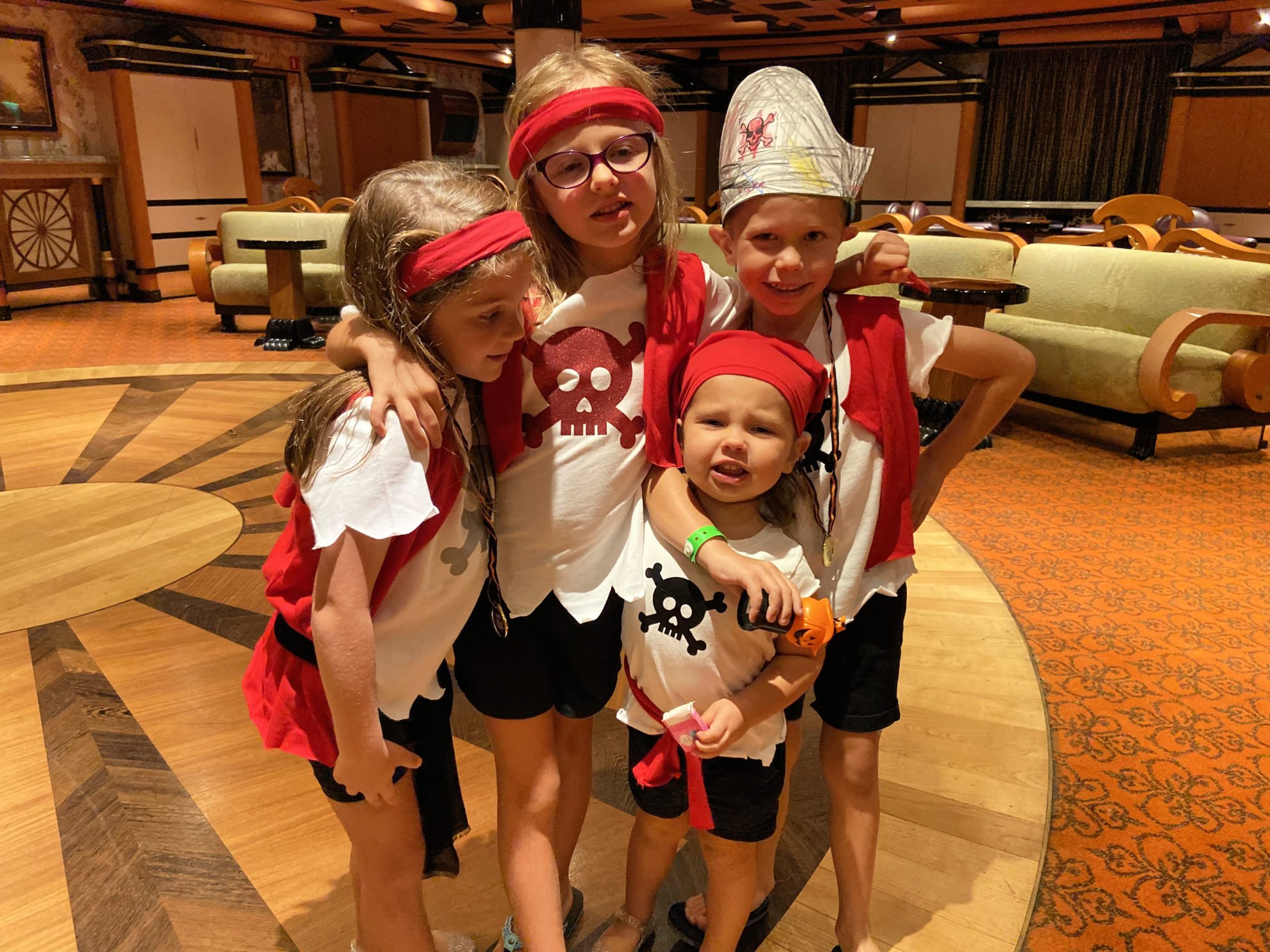 Four kids dressed in pirate shirts.