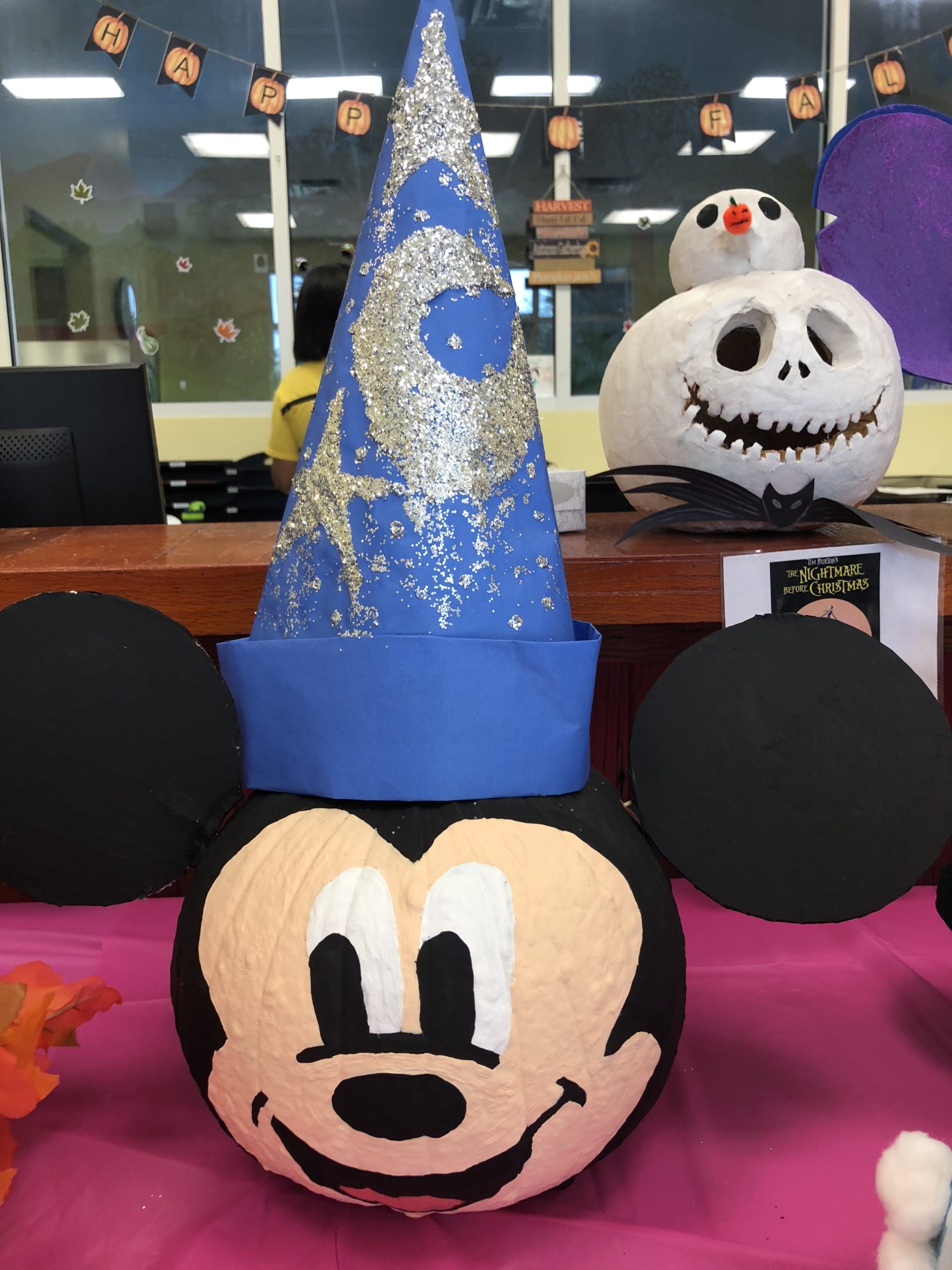 Sorcer Mickey Mouse painted pumpkin with cardboard ears and blue hat.