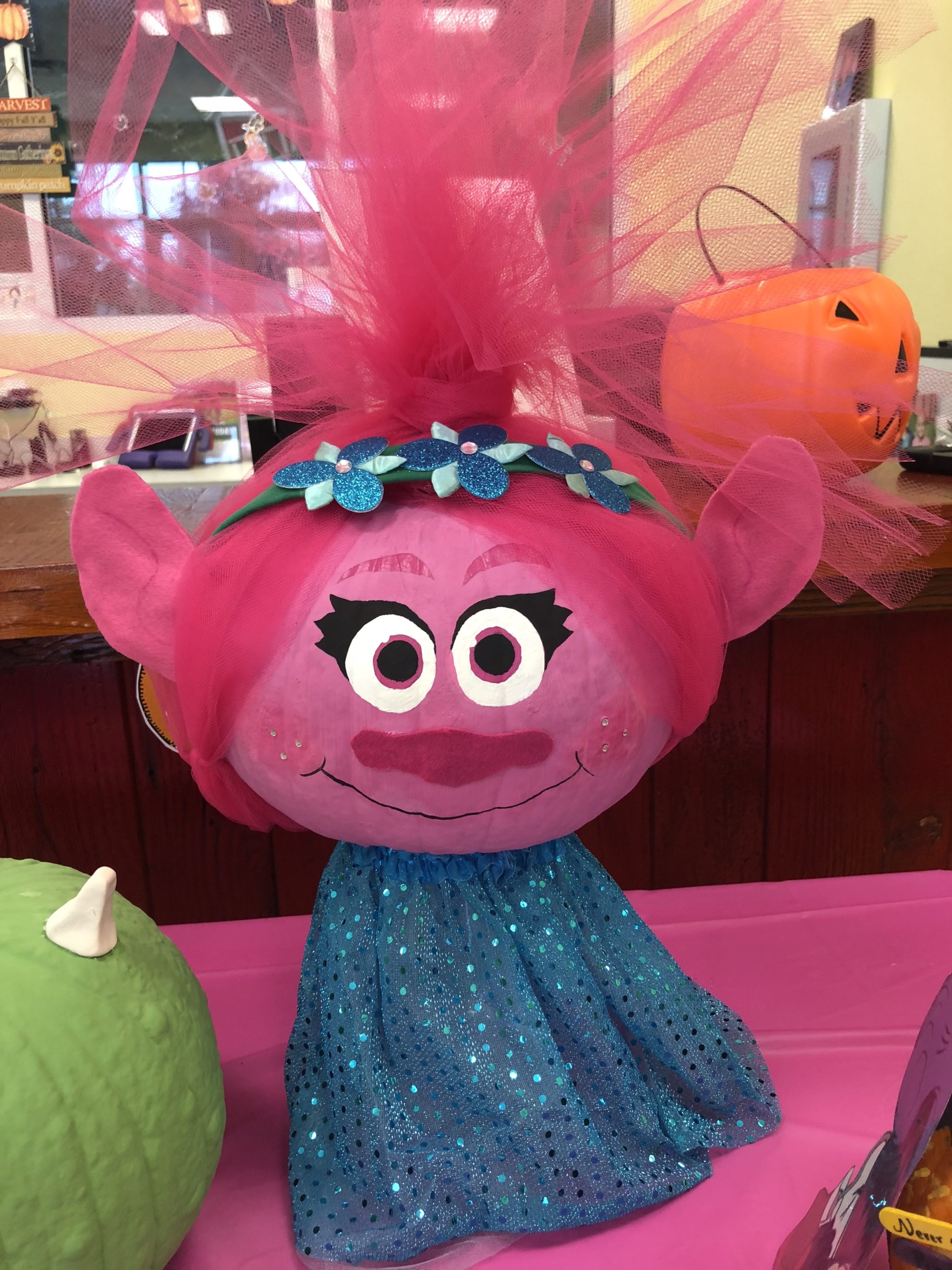 Pink poppy painted pumpkin with pink tulle for hair.
