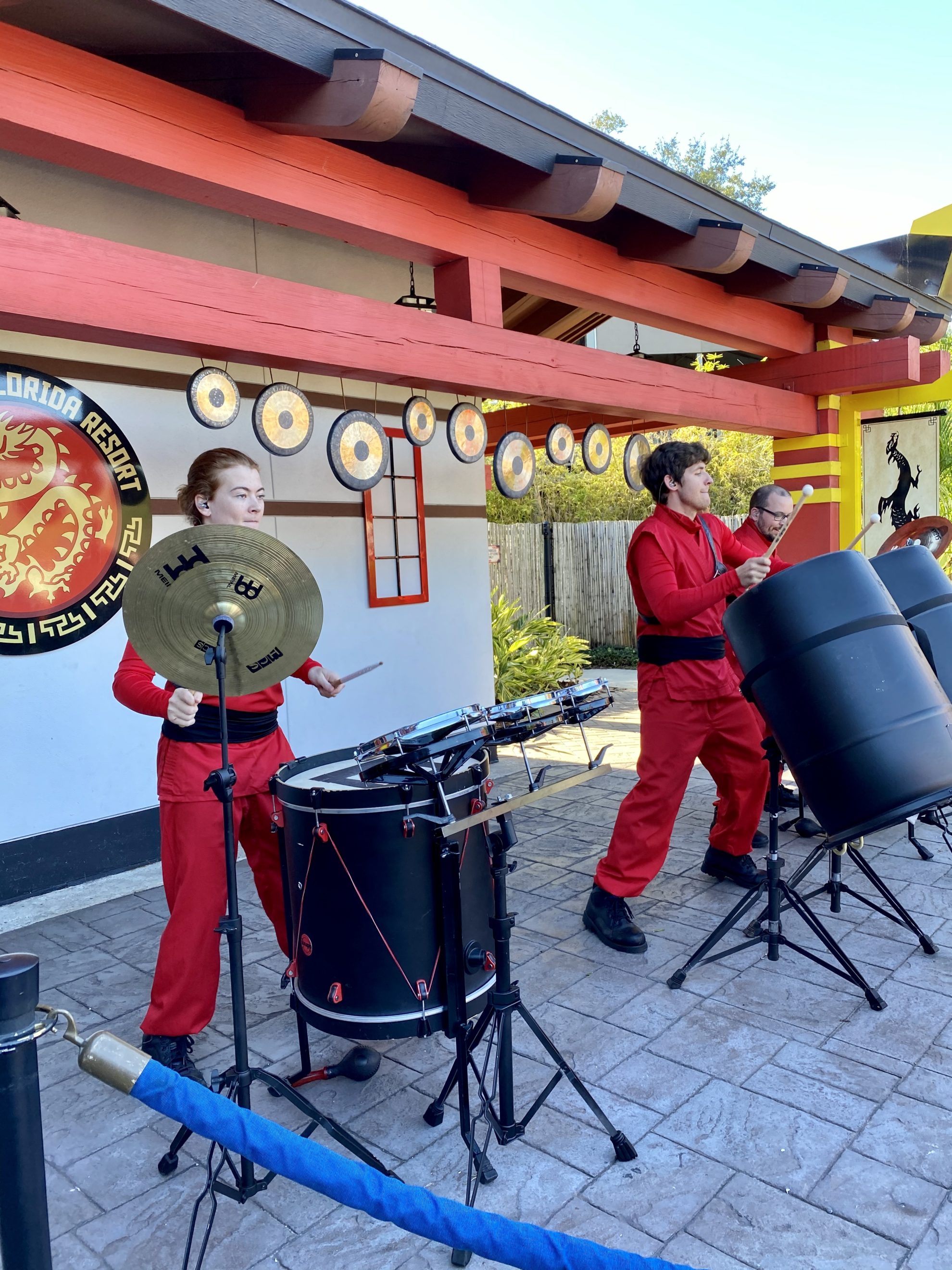 3 people from Earth Beats playing drums at NINJAGO Days.