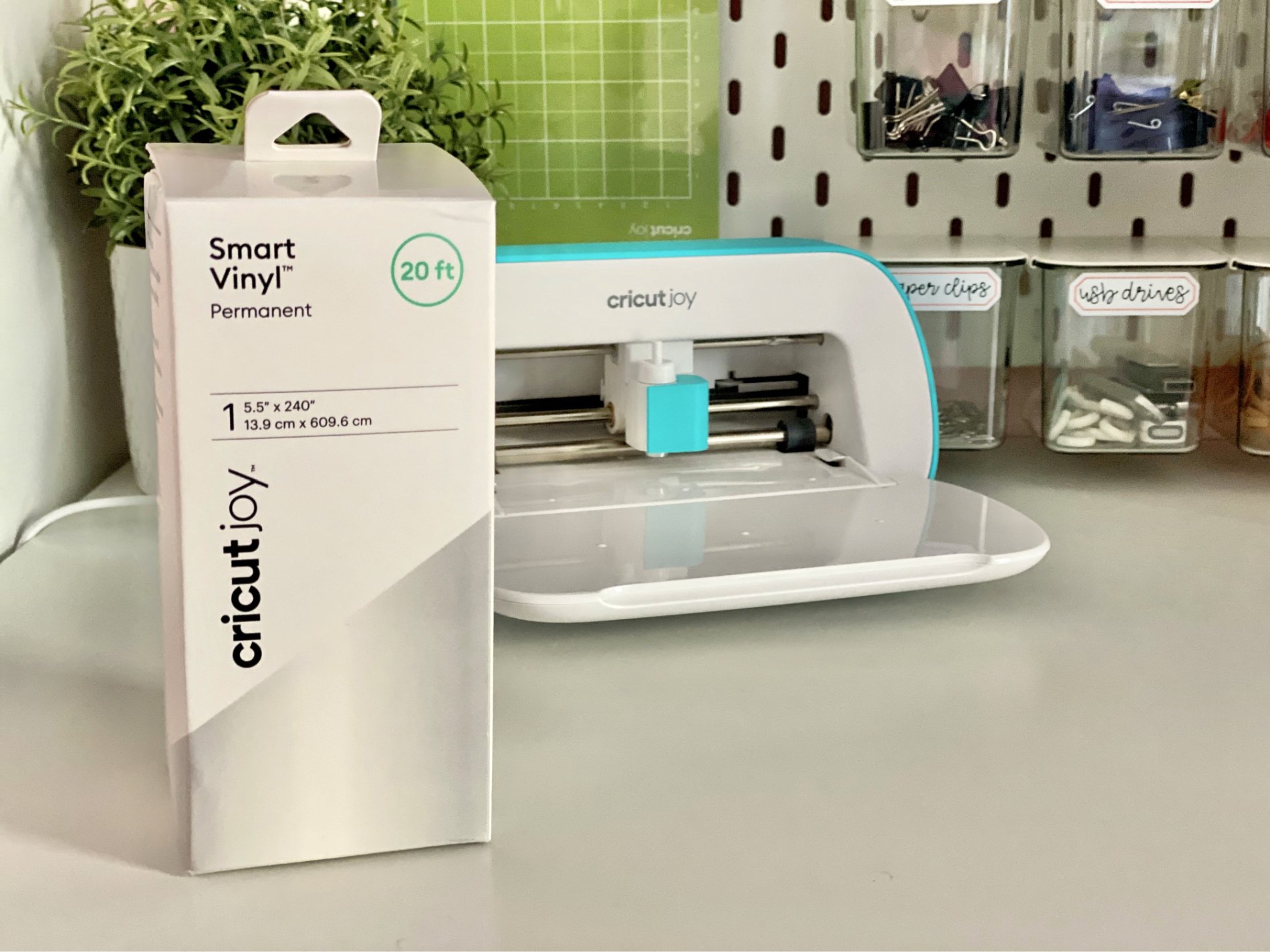 Box of Smart Vinyl standing on a white table with a Cricut Joy machine in the background.