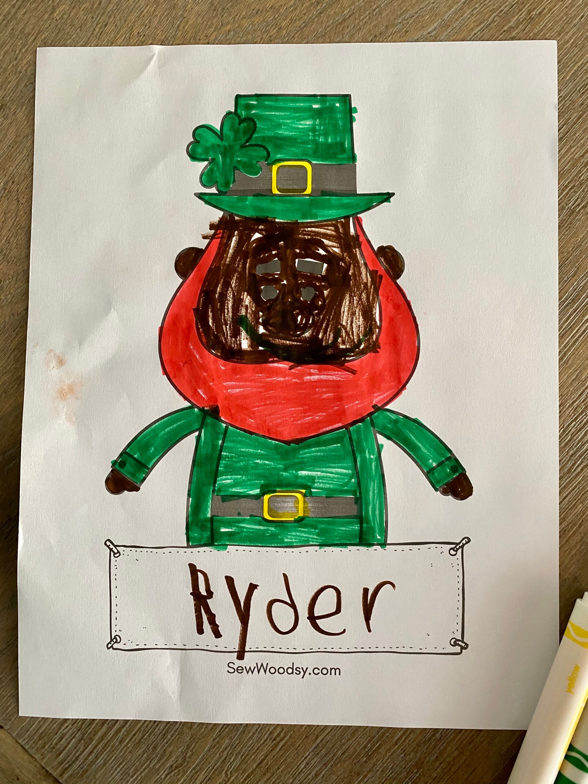 Colored leprechaun coloring sheet with childs name on paper.