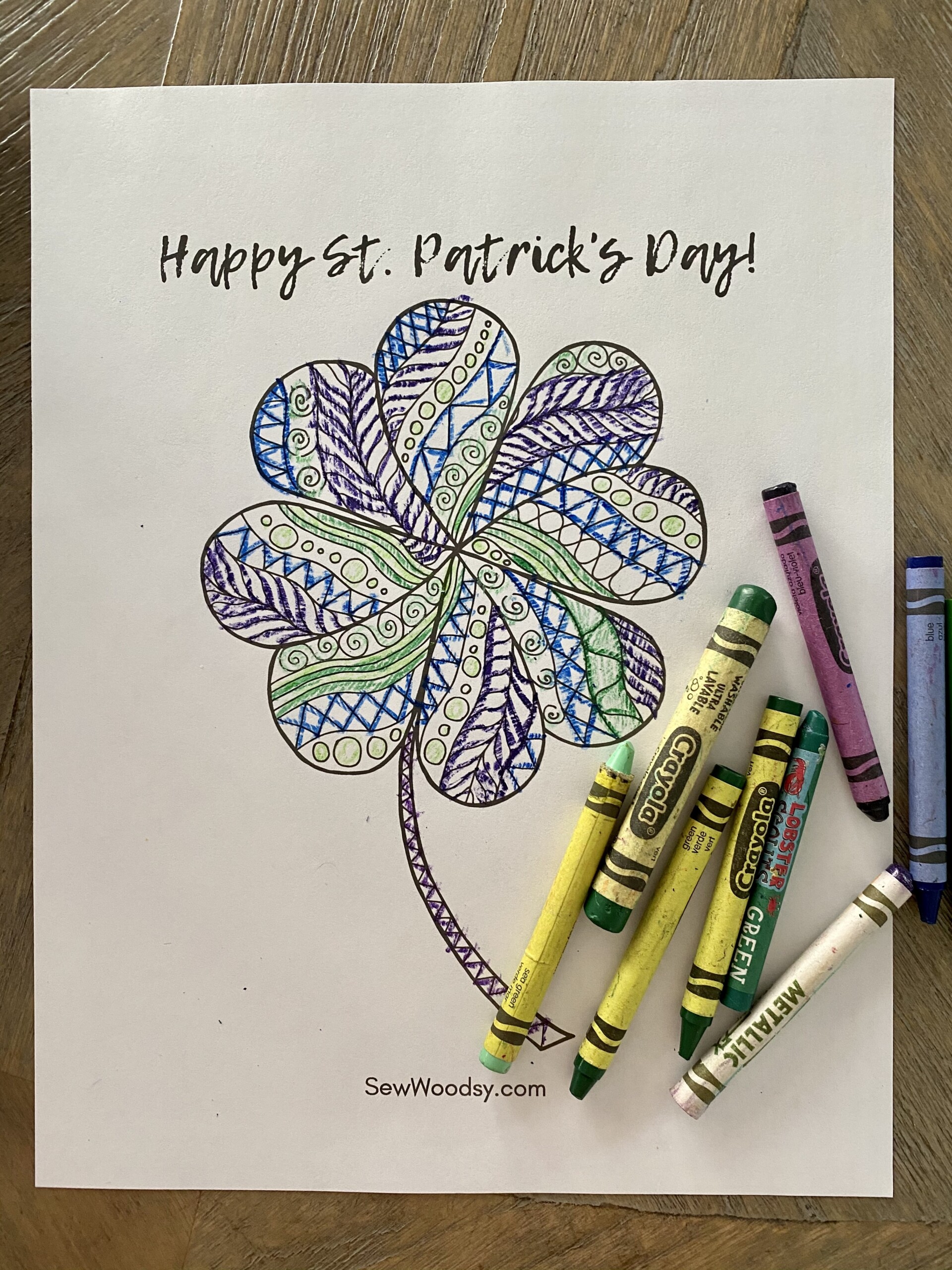 Coloring page with crayons on page that says "Happy St. Patrick's Day".