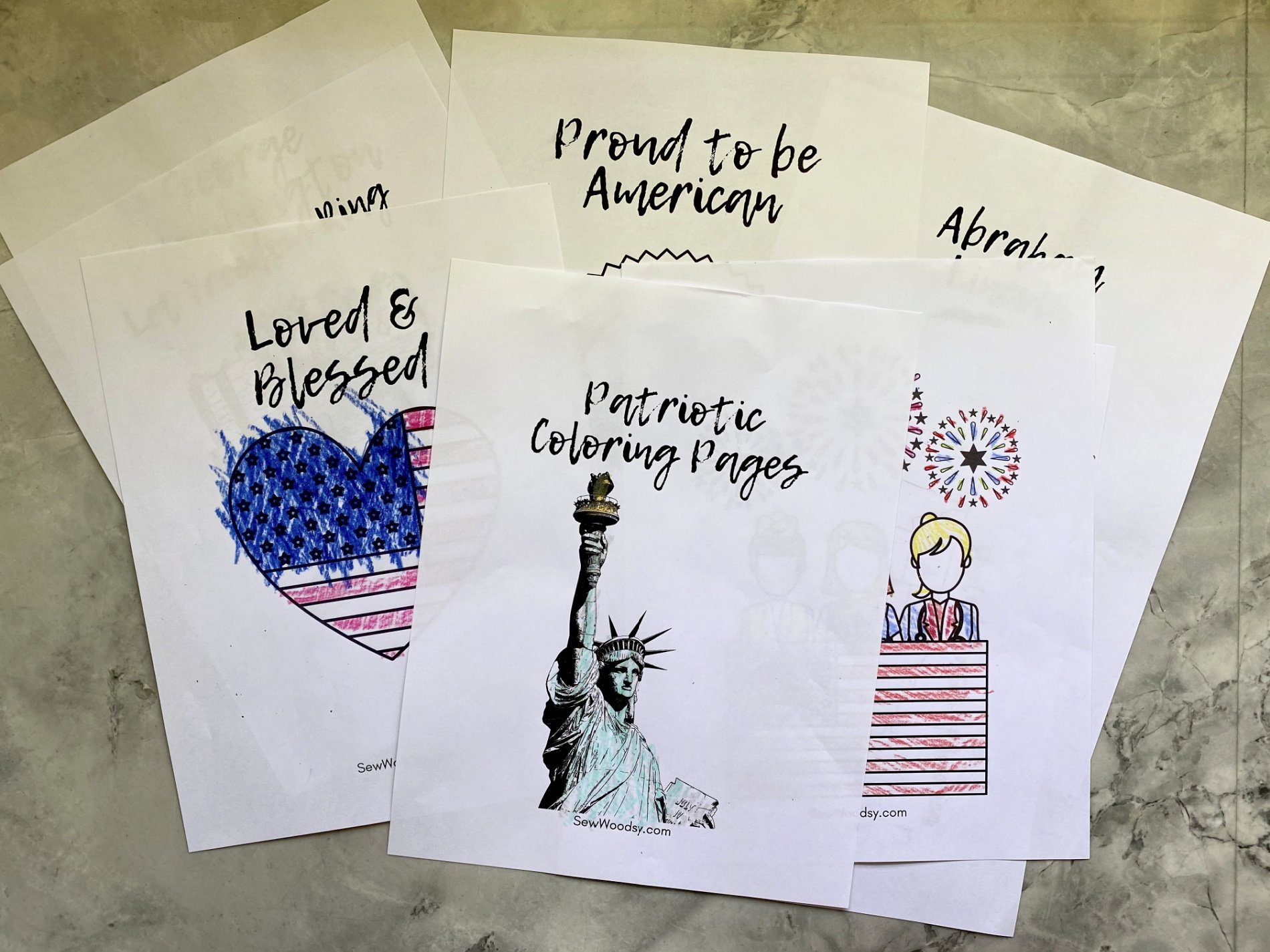 Multiple white papers with various printed and colored patriotic images and text.