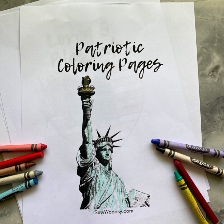 White coloring pages on marble countertop. Top coloring page of statue of liberty with crayons surrounding it.