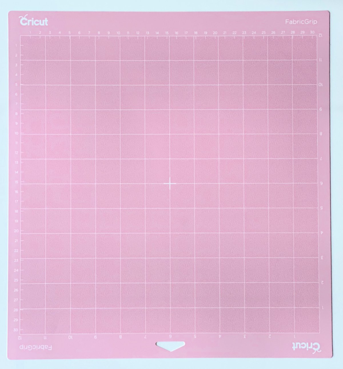 Light pink Cricut FabricGrip Mat on a white surface.
