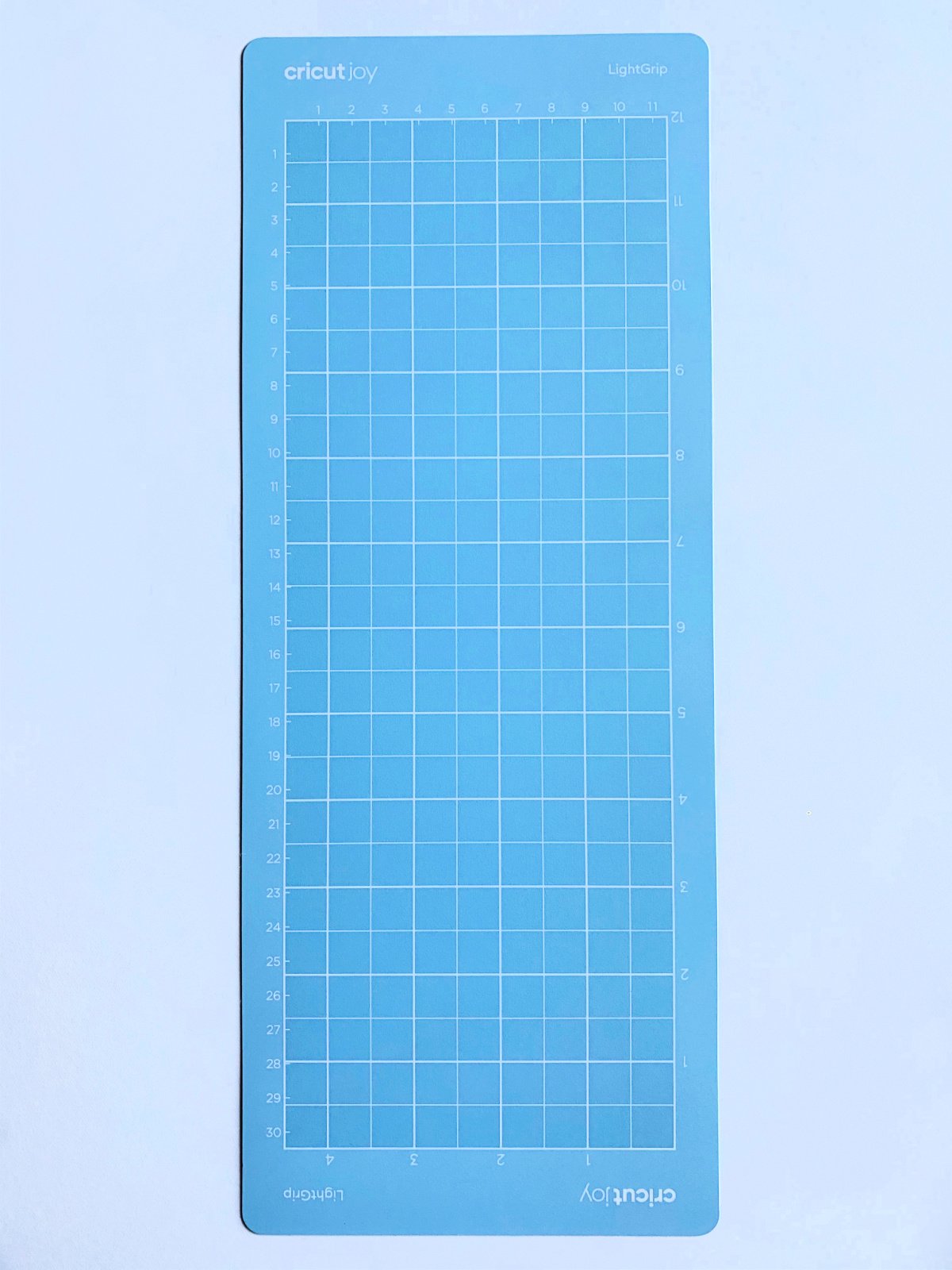 One light blue Cricut Joy LightGrip long mat on a white surface.