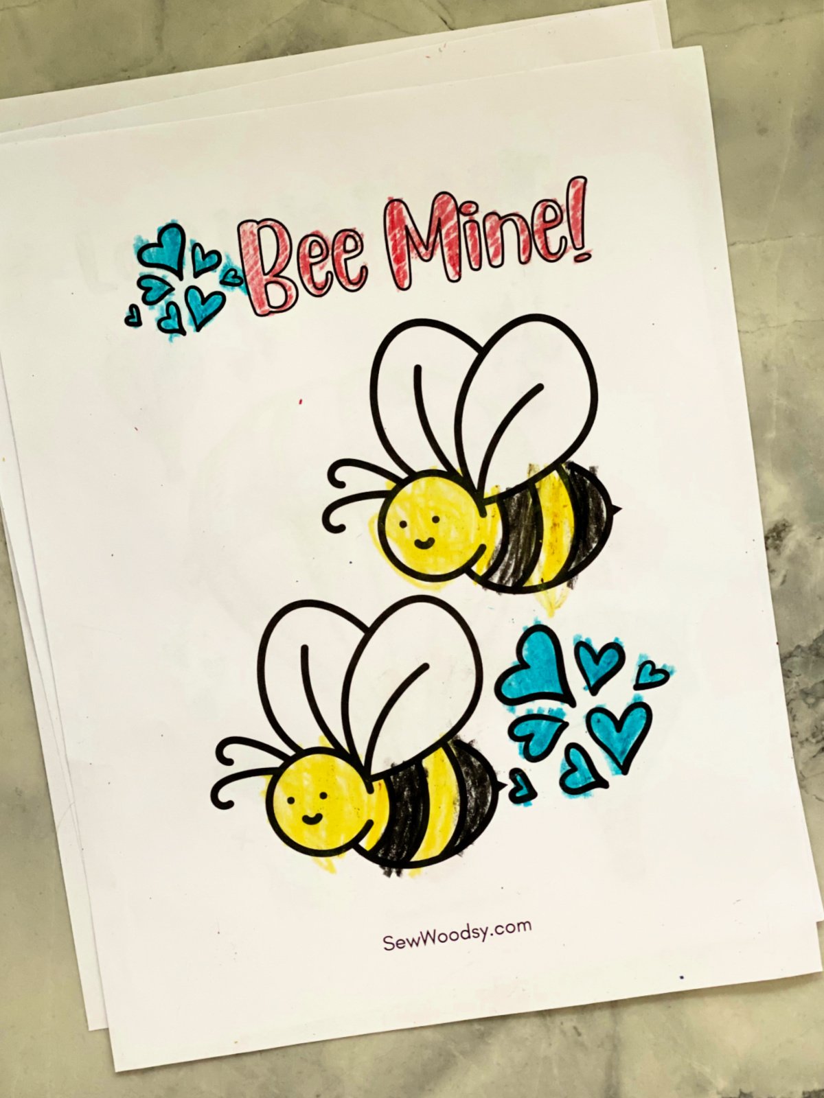 Two bees on a page that are colored in with the phrase "Bee Mine!"