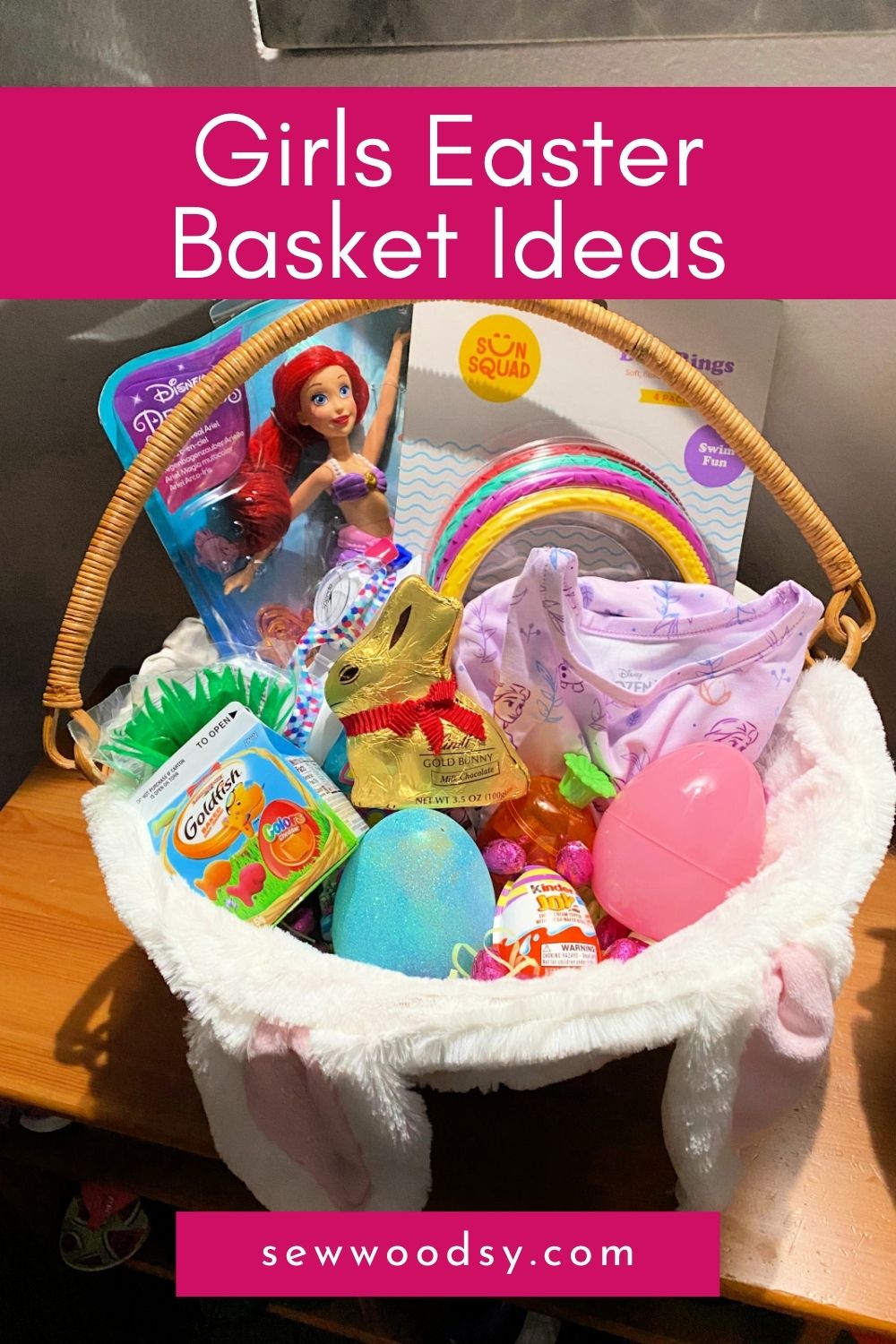 Easter basket filled with dolls, candy, and clothes with text on image for Pinterest.
