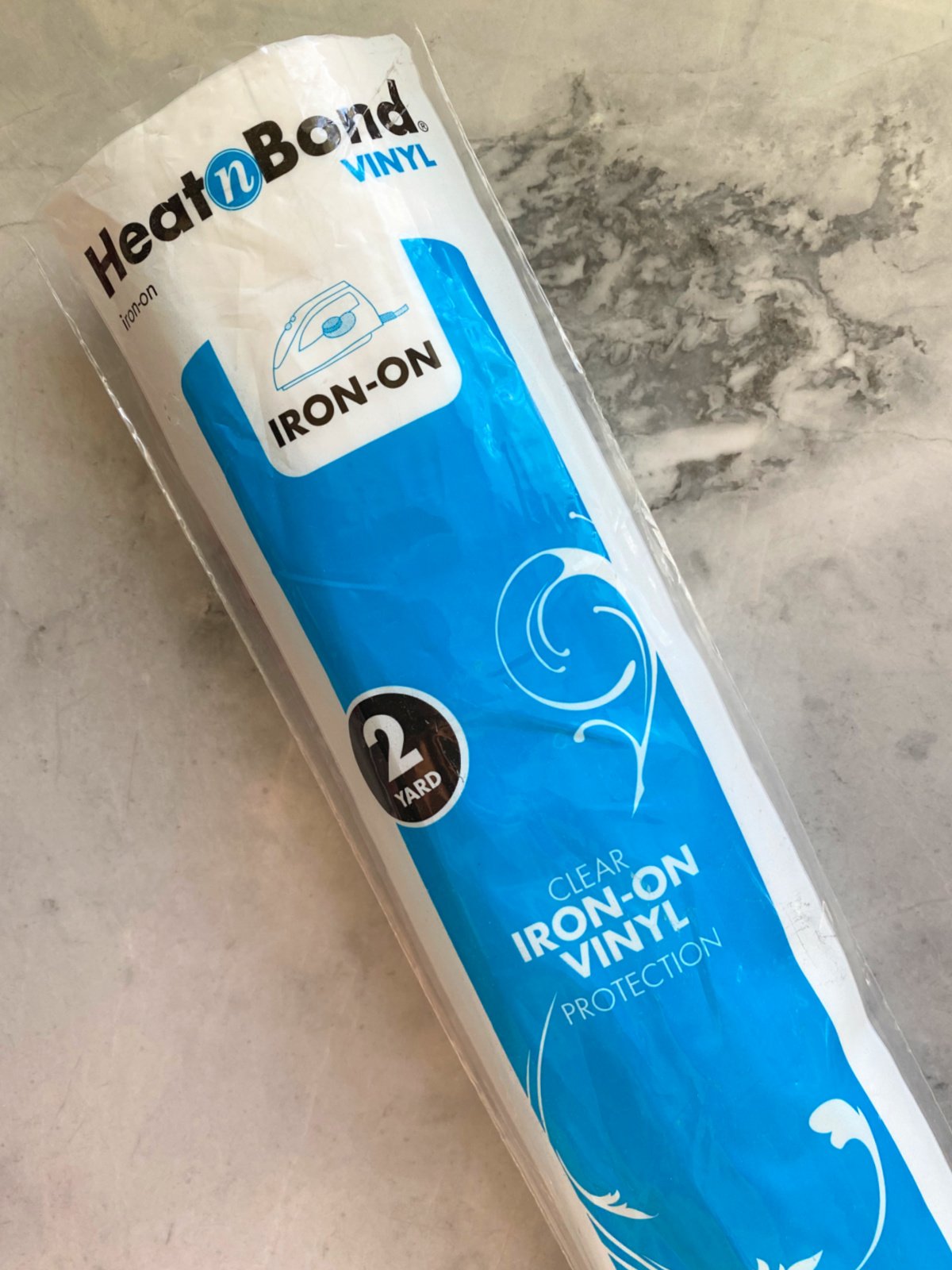 Heat n bond vinyl tube in packaging on a marble countertop.