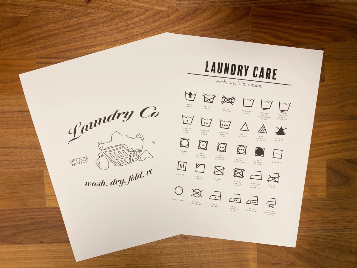 Two laundry printable papers on a wood surface.
