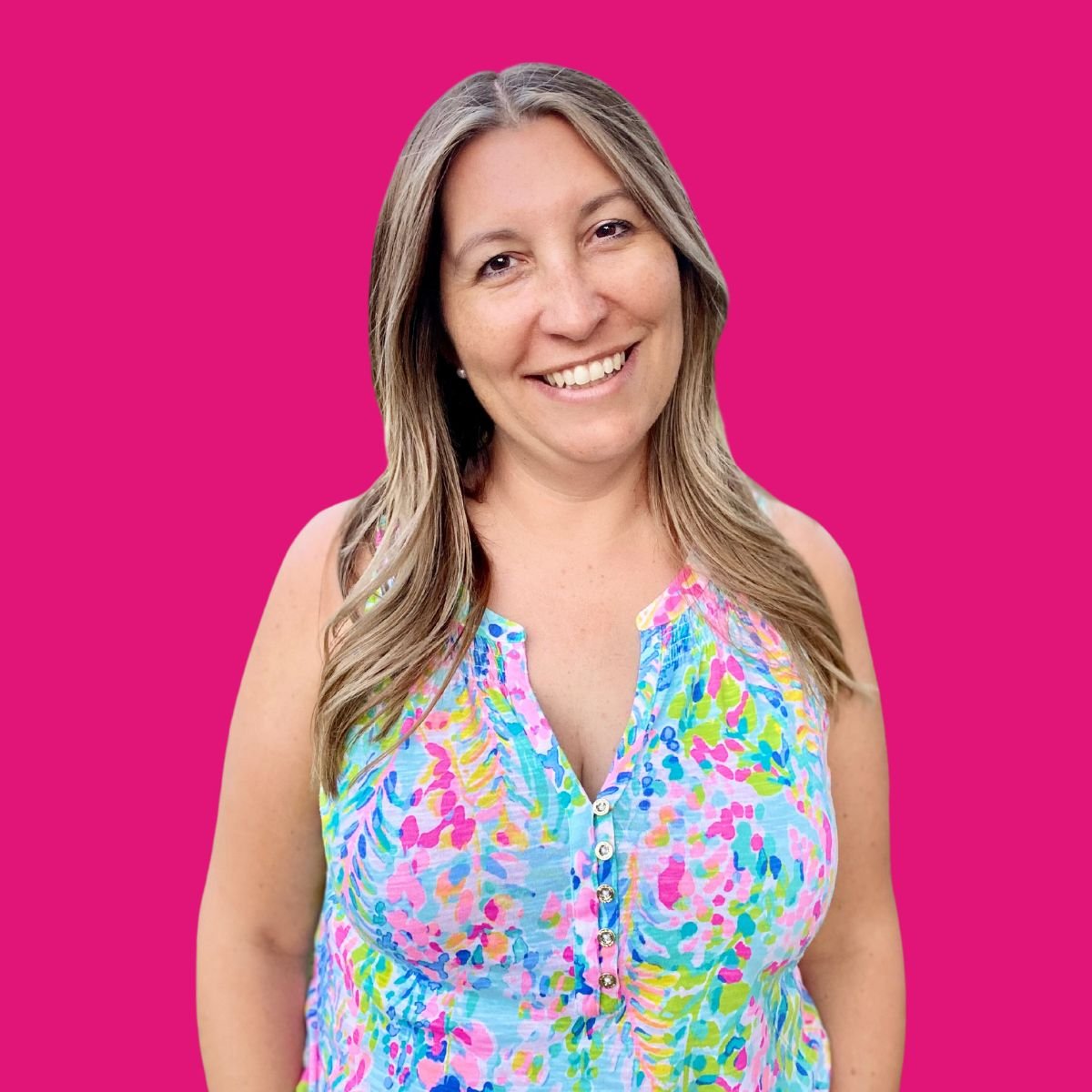 Female with light blonde and brown hair with colorful shirt and pink background.