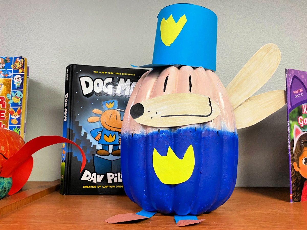 Dog Man pumpkin next to a Dog Man Book.