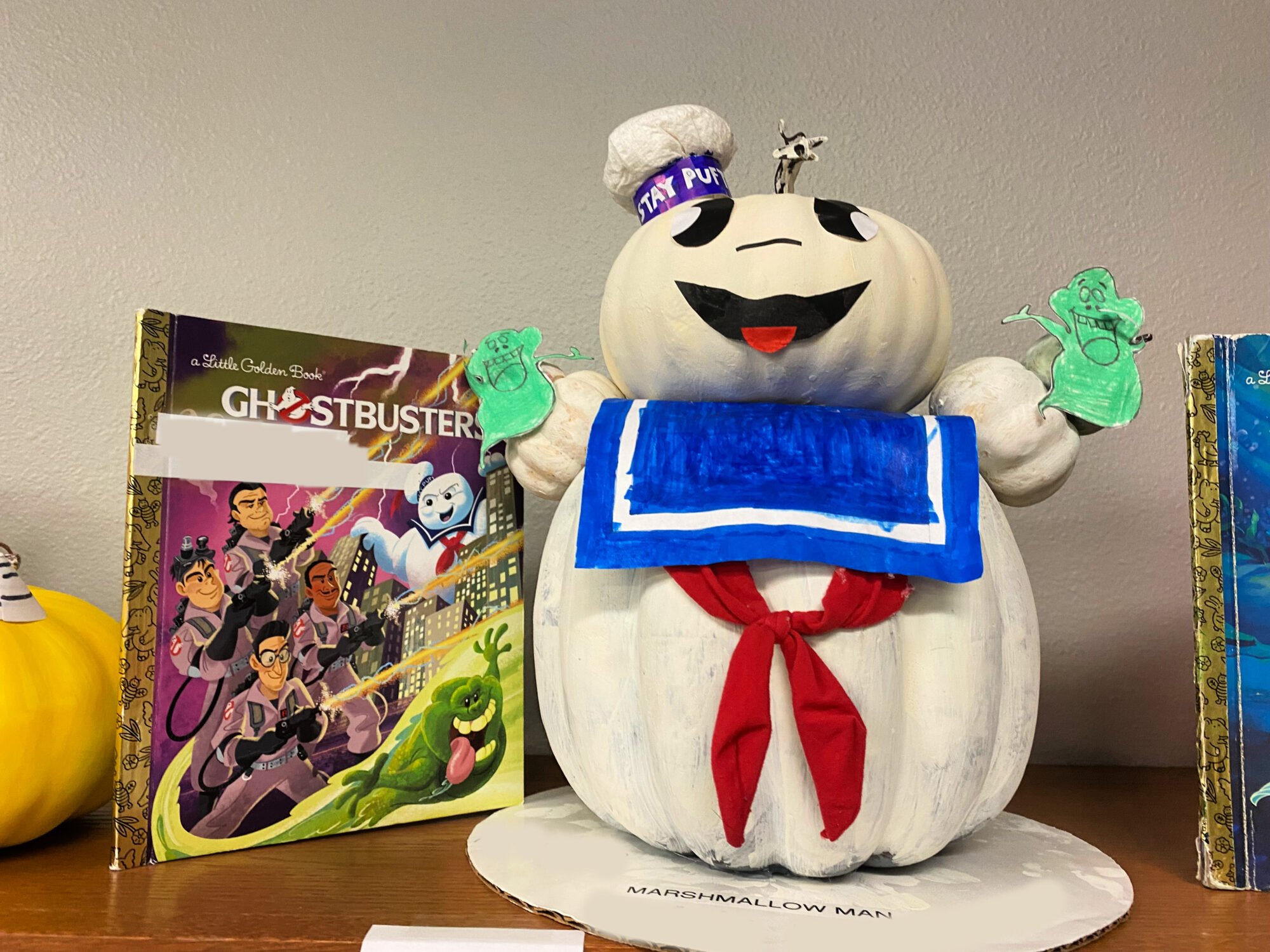 White marshmallow pumpkin next to a Ghostbusters book.