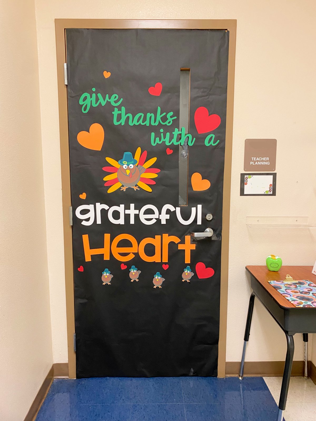 Black classroom door with a turkey and hearts.