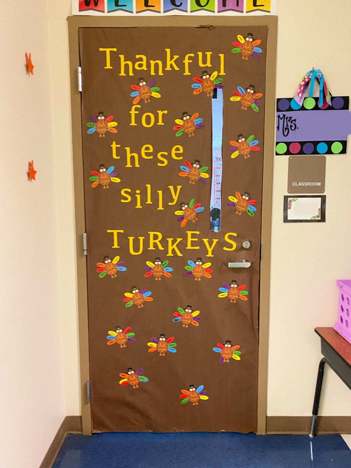 Brown classroom door with thanksgiving turkeys all over.