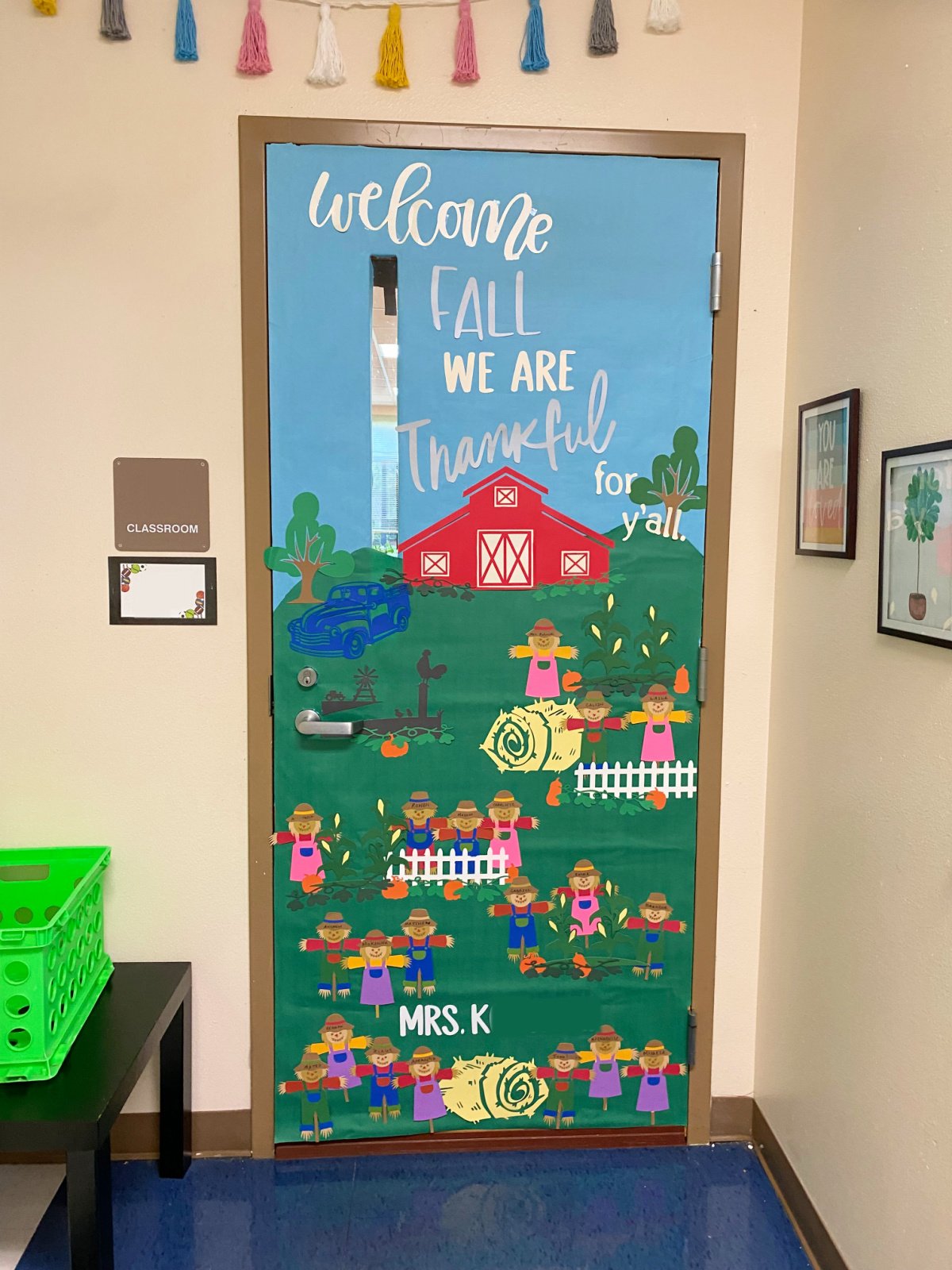 Farm inspired classroom door with scarecrows scattered around the door.