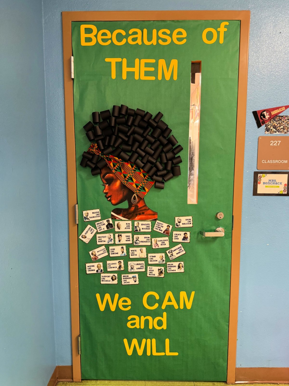 Green paper on door with african american woman with words "because of them we can and will"