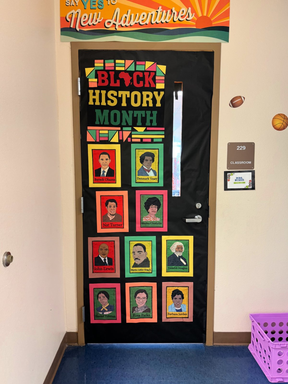 Black door with "black history month" and photos of influential Black historians.