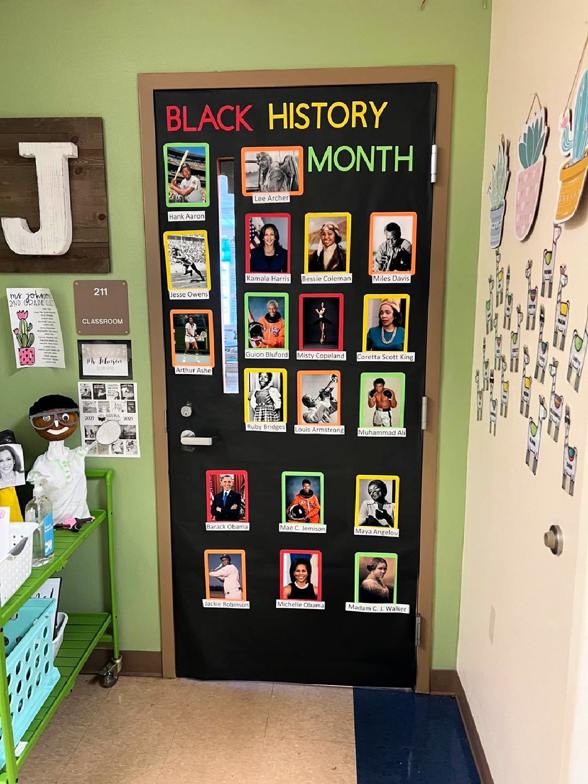 Black door with the words "black history month" and photos of influential African Americans.